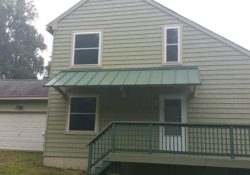 After- "New England Saltbox" Shake Siding, Double Hung Wiondows with Casings, Standing Seam Metal Covered Porch