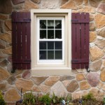 Window with Board and Batten Shutters on stone wall