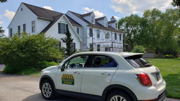 adding vinyl siding to a home after removing the moldy stone