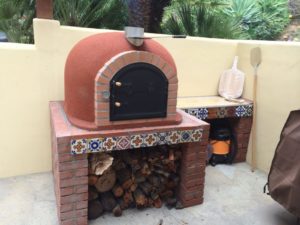 Add a counter beside your pizza oven to prepare the dough and toppings