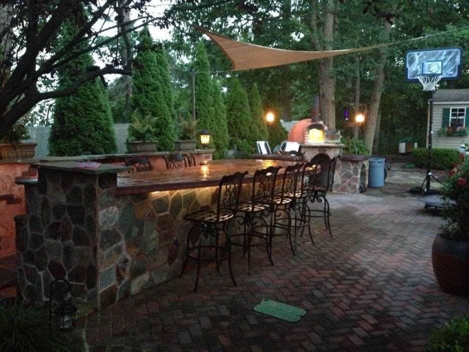 This authentic Italian Style Outdoor kitchen features a wood fired pizza oven