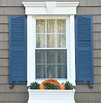 Exterior window with blue shutters